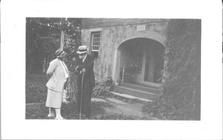 SA1405.20 - An unidentified man and woman outside building., Winterthur Shaker Photograph and Post Card Collection 1851 to 1921c